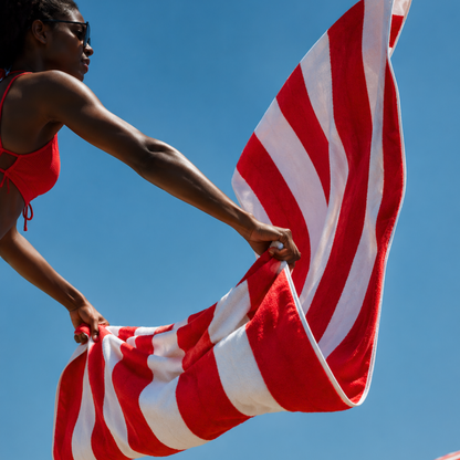 The lightweight red and white Zippa microfibre towel held open, showing its full size unzipped